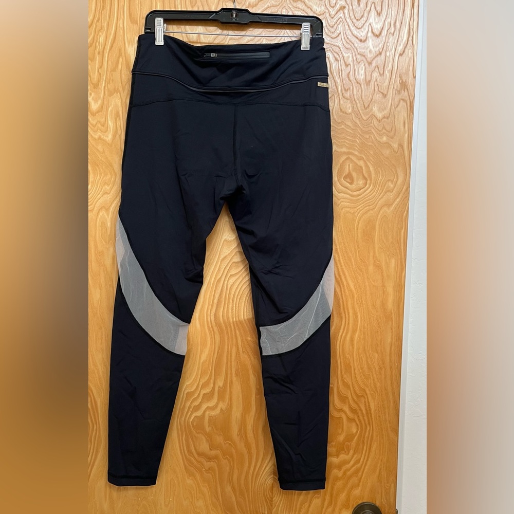 Alala large black high rise legging with mesh peek-a-poo inserts in good shape